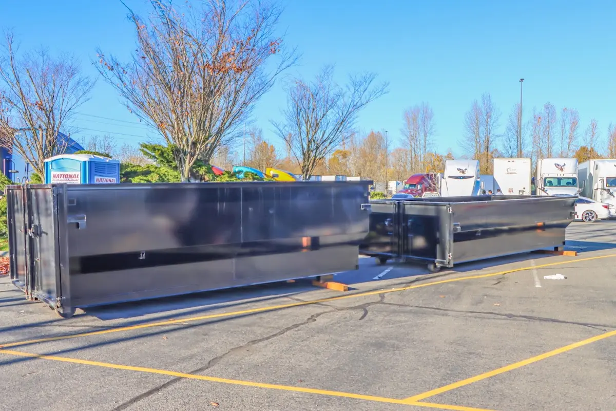 Professional dumpster rental service with roll-off container on residential driveway in North Arlington